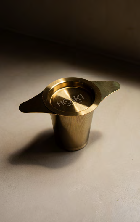 Premium gold stainless steel teacup infuser by Heart Therapeutics