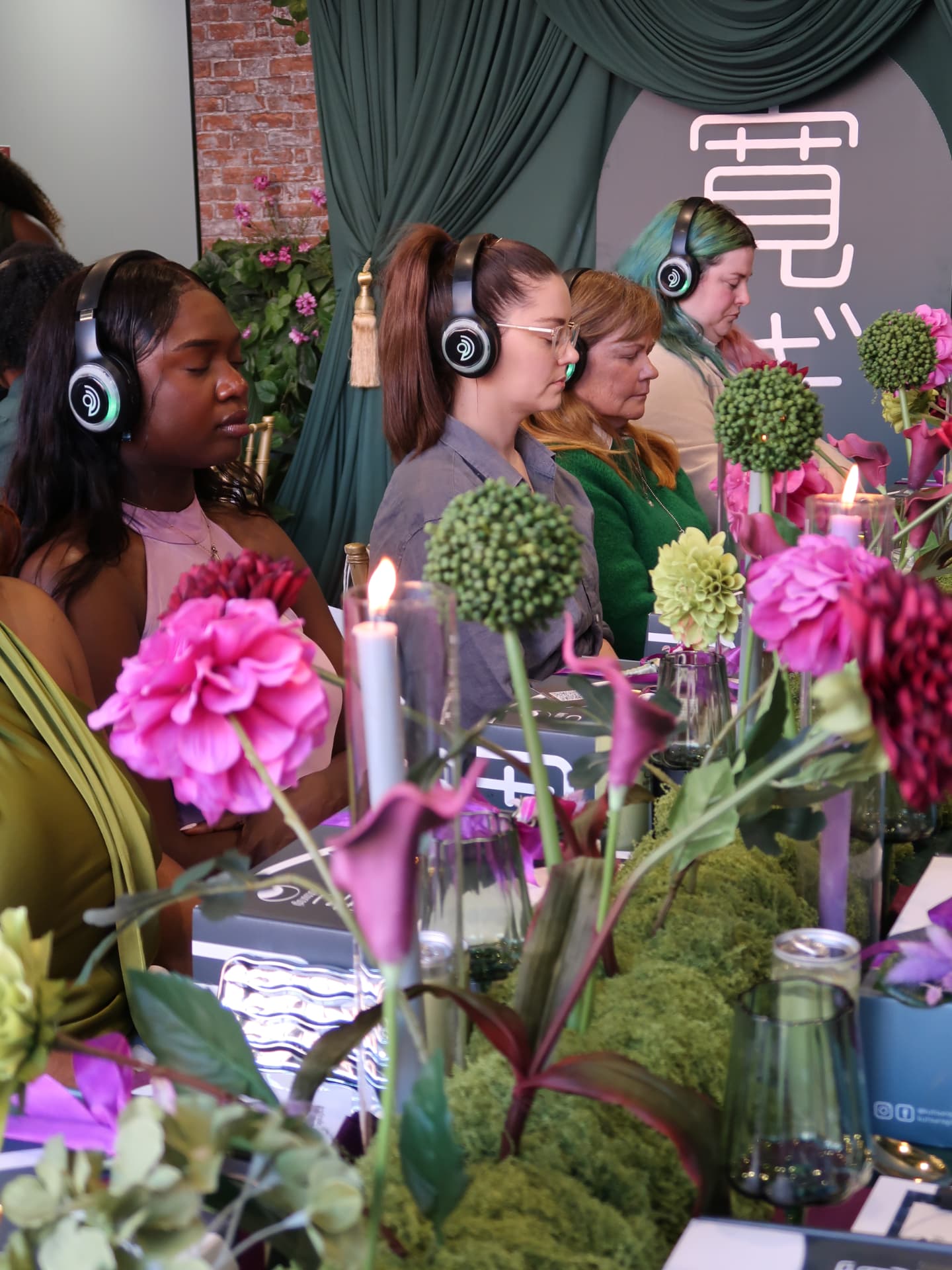 Professionals wearing headphones during a guided corporate breathwork session