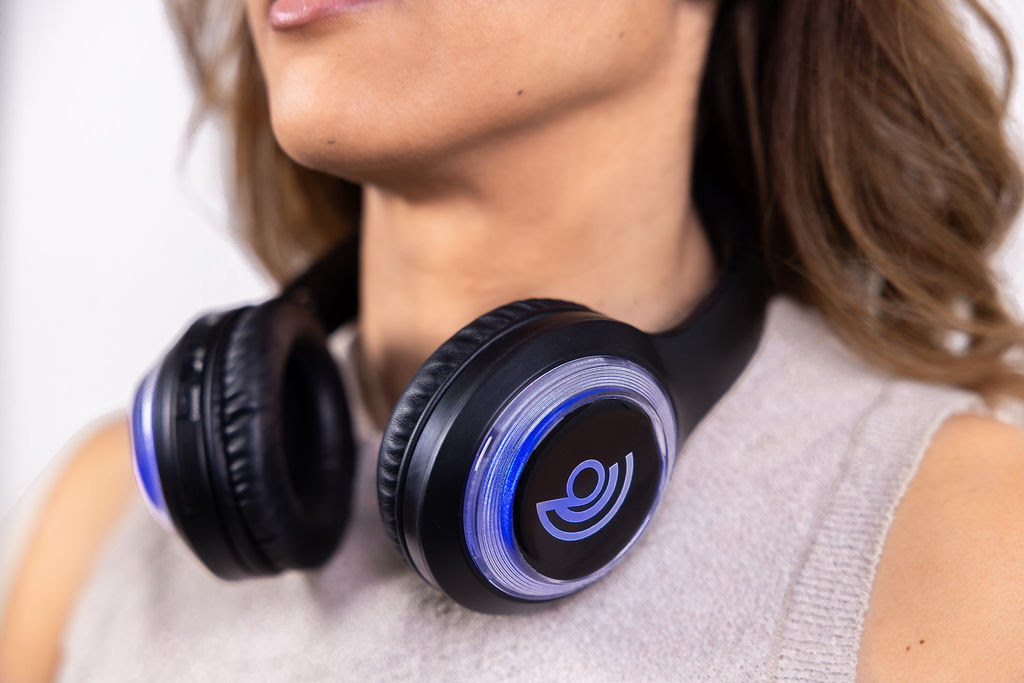 Client wearing 9D Breathwork headphones around the neck
