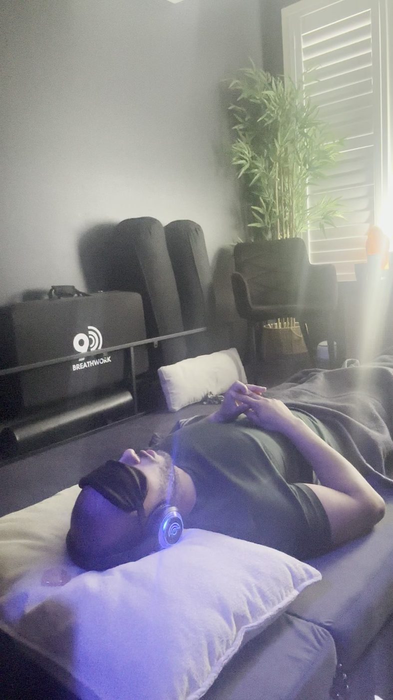 Male client seated in the studio before a breathwork session